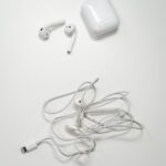 white earbuds on white surface