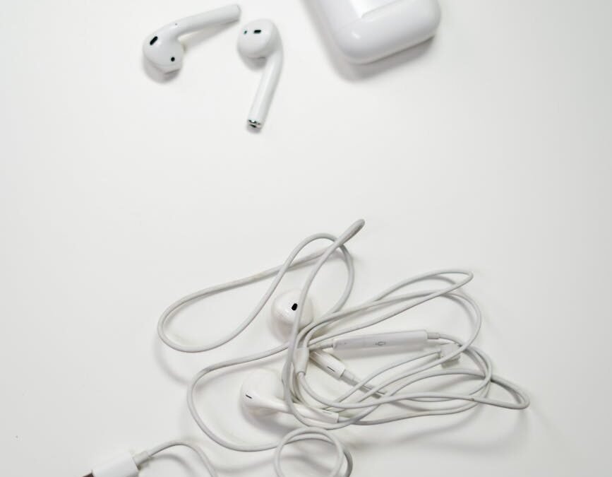 white earbuds on white surface