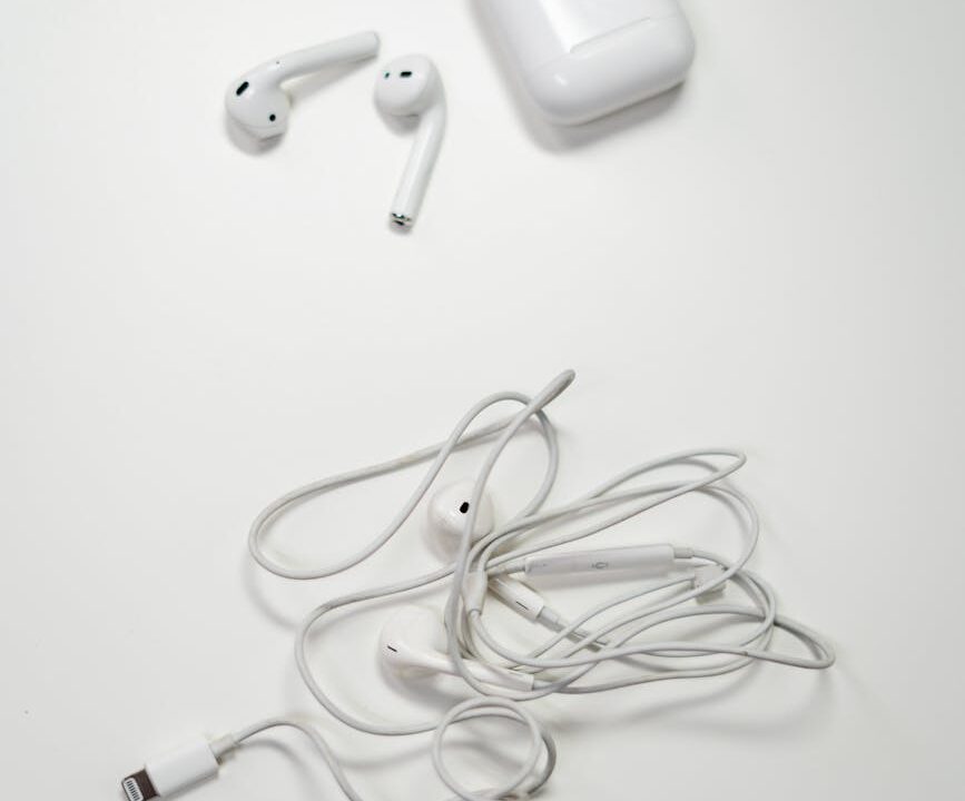 white earbuds on white surface