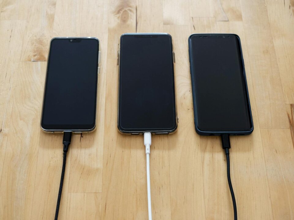 black android smartphones on brown wooden surface